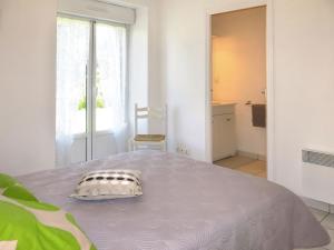 a bedroom with a bed with a pillow on it at Holiday Home Le Petit Maître by Interhome in Le Tronchet +15 photos
