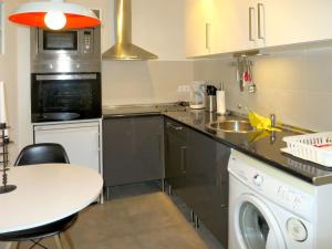 a kitchen with a sink and a washing machine at Holiday Home Ki - ATE248 by Interhome in La Nucía