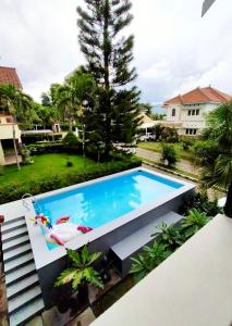 a swimming pool in the backyard of a house at Vila Batu Bale-Bale in Batu