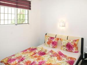 a bedroom with a bed and two pillows at Holiday Home Ingeborg by Interhome in Vilafortuny