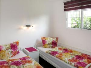a room with two beds and a window at Holiday Home Ingeborg by Interhome in Vilafortuny