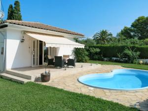 a backyard with a swimming pool and a house at Holiday Home Ingeborg by Interhome in Vilafortuny