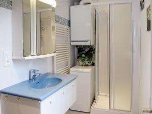 a bathroom with a sink and a toilet at Holiday Home La Mesnièroise by Interhome in Mesnières-en-Bray