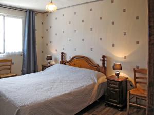 a bedroom with a bed and two chairs and a window at Holiday Home Entre mer et campagne 3 by Interhome in Le Mesnil-Saint-Martin