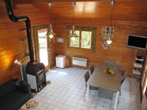 a living room with a table and a stove at Holiday Home L'Escouarte - MAU170 by Interhome in Maubuisson