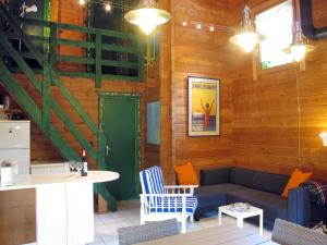 a living room with a couch and a table at Holiday Home L'Escouarte by Interhome in Maubuisson