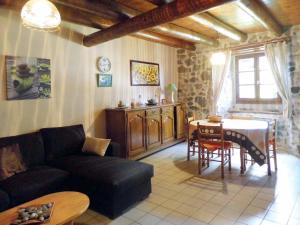 a living room with a couch and a table at Holiday Home Le Haut d'Ancette - AJA100 by Interhome in Saint-Julien-dʼAnce
