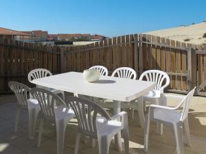 a white table and chairs on a patio at Holiday Home Résidence Plage Océane - BPL343 by Interhome in Biscarrosse-Plage