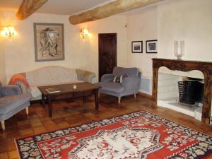 a living room with a couch and chairs and a fireplace at Holiday Home Les Puits Neufs by Interhome in Cavaillon