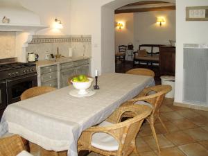 a kitchen with a table with a bowl of fruit on it at Holiday Home Les Puits Neufs by Interhome in Cavaillon