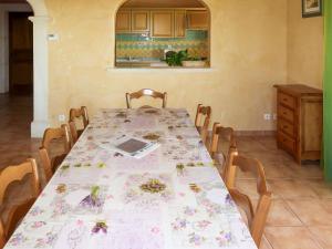 a table in a kitchen with a table cloth on it at Holiday Home Plan du Vas by Interhome in Valréas