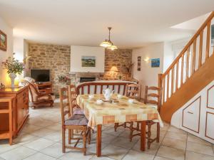 a dining room with a table and chairs at Holiday Home Ty Breiz - POE102 by Interhome in Ploemeur