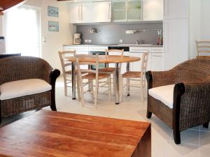 a kitchen with a wooden table and chairs at Holiday Home Ty Croisic - PEM118 by Interhome in Penmarch