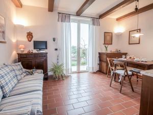 a living room with a couch and a table at Villa Olindia by Interhome in San Savino