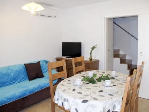 a living room with a table and a couch at Holiday Home Antica - PUT103 by Interhome in Punat