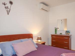 a bedroom with a bed and a dresser at Holiday Home Antica - PUT103 by Interhome in Punat