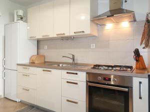 a kitchen with white cabinets and a sink and a stove at Holiday Home Antica - PUT103 by Interhome in Punat