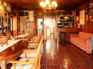 a restaurant with tables and chairs and a couch at Holiday Home Delfar by Interhome in Nerezine