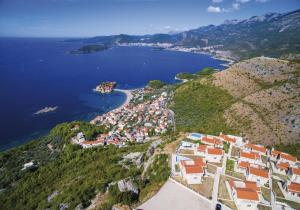 an aerial view of a village on a hill next to the ocean at Carsko Selo Blizikuce in Budva