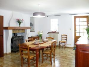 a dining room with a table and a fireplace at Holiday Home Mas de l'Adrech by Interhome in Fayence