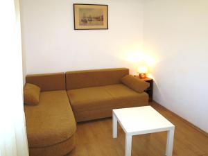 a small living room with a couch and a table at Apartment Klarić-1 by Interhome in Trogir