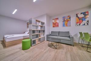 a living room with a couch, coffee table and bookshelf at Apartamenty Collegia in Gdańsk