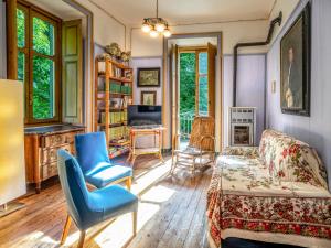 a living room with a couch and chairs at Holiday Home Villa Biino by Interhome in Ala di Stura