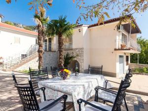 a table with a vase of flowers on it at Holiday Home Mazor - NOV400 by Interhome in Bribir