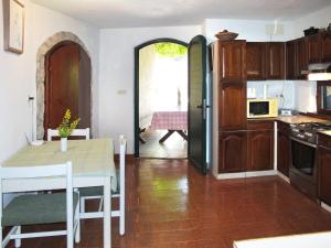 a kitchen with a table and a dining room at Holiday Home Mick - ICS400 by Interhome in Cres