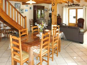 a dining room with a wooden table and chairs at Holiday Home Le Chomeil by Interhome in Chamalières-sur-Loire