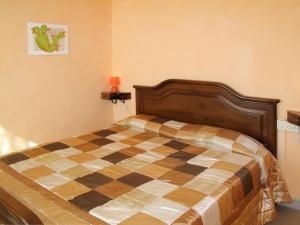 a bedroom with a checkered bed in a room at Apartment Roma - SLR219 by Interhome in Cipressa
