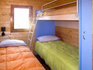 a bedroom with two bunk beds and a ladder at Holiday Home Le Terrazze del Geco Bungalow B - SLR301 by Interhome in San Lorenzo al Mare +50 photos