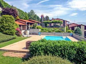 a house with a swimming pool in a yard at Apartment Bellavista Erika 19 by Interhome in Cademario