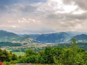 a view of a city with mountains in the background at Apartment Bellavista Erika 19 by Interhome in Cademario