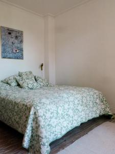 a bedroom with a bed with a green comforter at ApartmentInCopenhagen Apartment 113 in Copenhagen