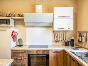 a kitchen with wooden cabinets and a white refrigerator at Holiday Home di Pipot by Interhome in Pettenasco +21 photos