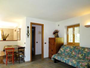 a living room with a couch and a table at Holiday Home Alpe by Interhome in Brissago Valtravaglia