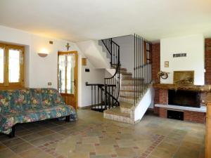 a living room with a couch and a fireplace at Holiday Home Alpe by Interhome in Brissago Valtravaglia