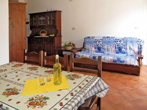 Sala de estar con mesa y botella de vino en Apartment La Colombera-6 by Interhome, en Diano Castello