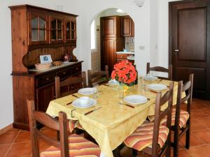 a dining room with a wooden table and chairs at Apartment La Colombera - DIA142 by Interhome in Diano Castello