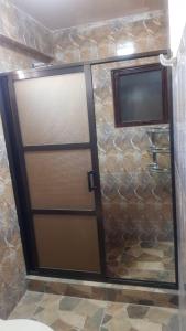a bathroom with a shower with a sliding door at Asian House in Uyuni +2 photos