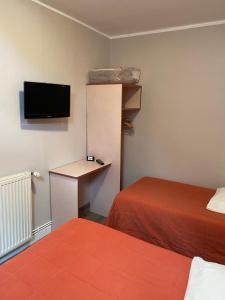 A bed or beds in a room at Hotel & Restaurant Hanoï Station