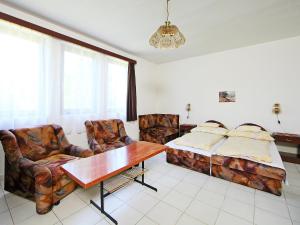 a living room with a bed and a table and chairs at Holiday Home Sunlight by Interhome in Balatonőszöd