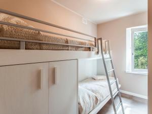 a bedroom with two bunk beds and a ladder at Apartment Iris e Girasole by Interhome in Manerba del Garda