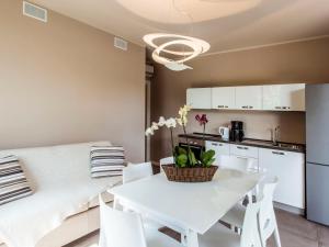 a living room with a white table and white chairs at Apartment Iris e Girasole by Interhome in Manerba del Garda