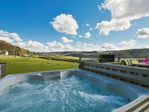 a hot tub on the balcony of a house at Browside in Coniston