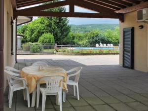 a table and chairs sitting on a patio at Apartment Colombaro Nuovo-5 by Interhome in San Felice del Benaco