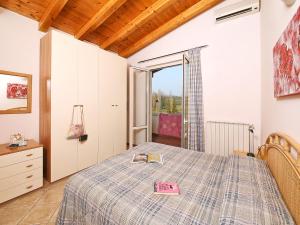 a bedroom with a bed with a book on it at Apartment Colombaro Nuovo-5 by Interhome in San Felice del Benaco