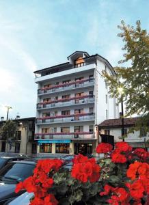 a large building with red flowers in front of it at Residence Saint-Vincent in Saint Vincent