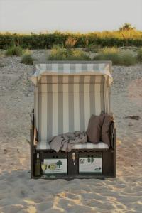 a dumpster sitting on the sand on a beach at Land & Meer in Hasselberg +15 photos